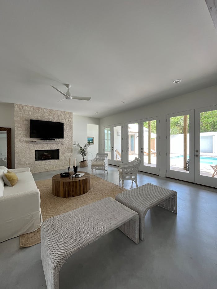 Spacious modern living room with elegant decor and a poolside view.